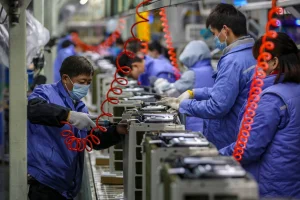 Employees work on an air conditioner production line at a Midea factory in Wuhan, in central China's Hubei province on December 14, 2020. (Photo by STR / AFP) / China OUT
